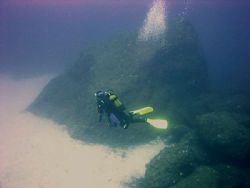 Diving off Cirkewwa reef, Malta,with 'sugar loaf'rock in ... by Ian Palmer 